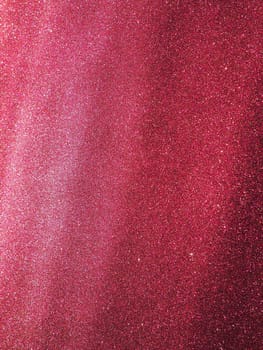 Bokeh light of pink glitters. Magenta glitter texture background. Sparkling glitter wrapping paper with sequins and sparkles. Festive purple bokeh and glitter. Diagonal stripes and waves.