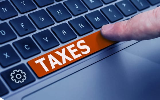 Sign displaying Taxes, Concept meaning contribution to state revenue levied by government on workers income