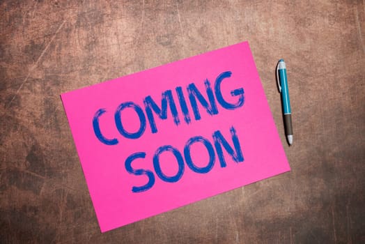 Hand writing sign Coming Soon, Internet Concept something is going to happen in really short time of period