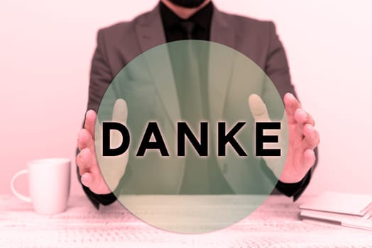 Sign displaying Danke, Word Written on used as informal way of saying thank you in German language Thanking