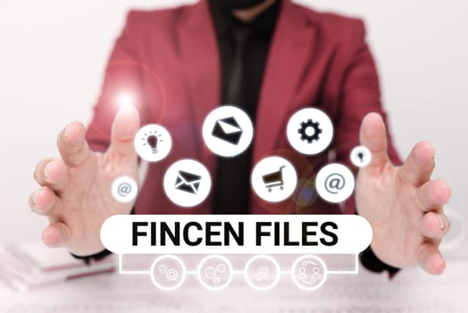 Sign displaying Fincen Files, Word for Transactions in financial assets and liabilities
