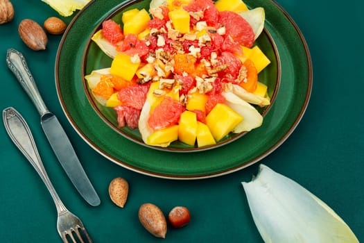 Chicory salad with fruits and walnut. Healthy meal recipe