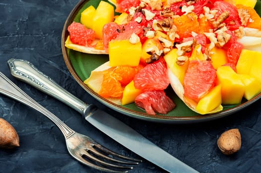 Chicory salad with fruits and walnut. Healthy meal recipe