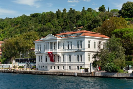 View from Bosphorus strait of the green mountains of the Asian side, with traditional houses and dense trees in a summer day, Istanbul, Turkey