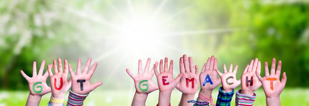Children Hands Building Colorful German Word Gut Gemacht Means Well Done. Sunny Green Grass Meadow As Background.