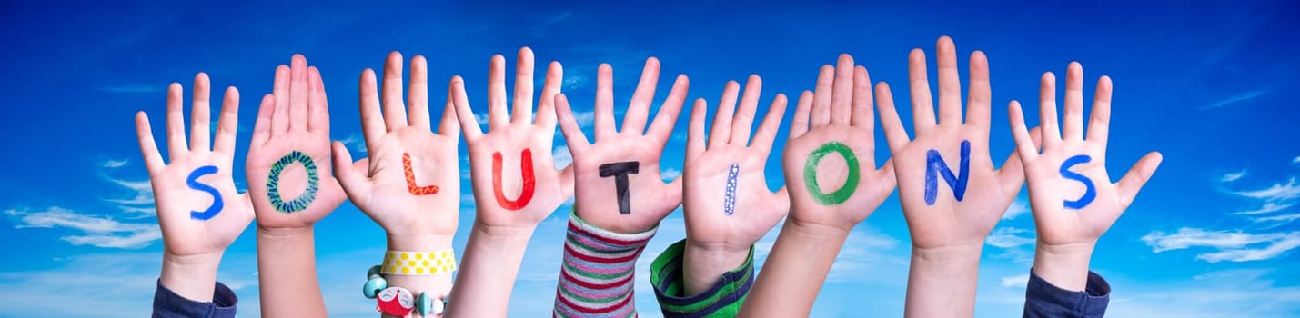 Children Hands Building Colorful English Word Solutions. Blue Sky As Background