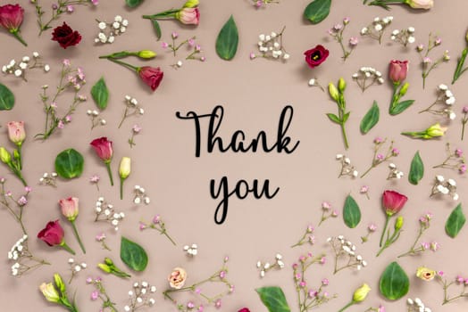 Flower Arrangement With English Text Thank You. Colorful Spring Blossoms And Flowers Like Roses Building A Frame. Flat Lay With Brown Paper Background
