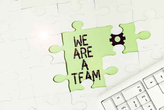 Text sign showing We Are A Team, Word for work together to accomplish a common vision or goals