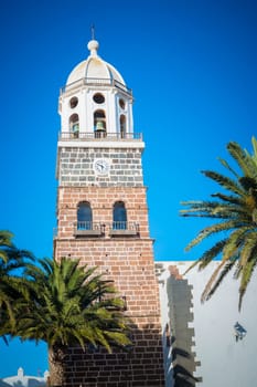 Teguise, Lanzarote, Spain, March 2023: View on the clock tower of the church of Teguise, former capital of the Spanish Canary island of Lanzarote