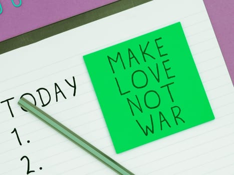 Text caption presenting Make Love Not War, Word Written on A hippie anti-war slogan encouraging love and peace