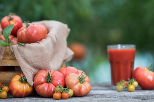 Fresh red tomato juice, on a wooden background
