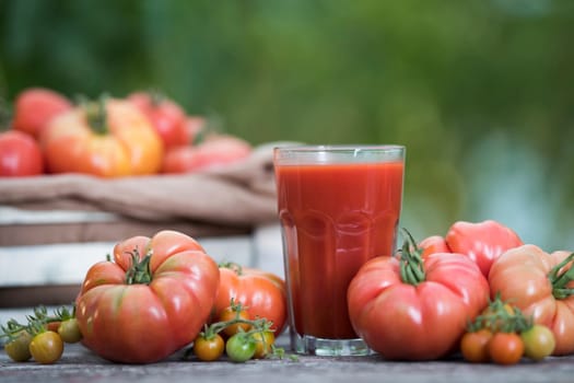 Fresh tomato juice, on a wooden background