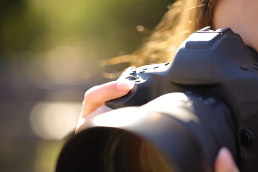 Close up portrait of a photographer finger pressing camera shutter button