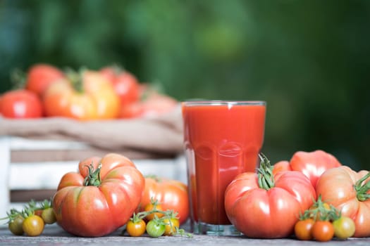 Fresh tomato juice, on a wooden background
