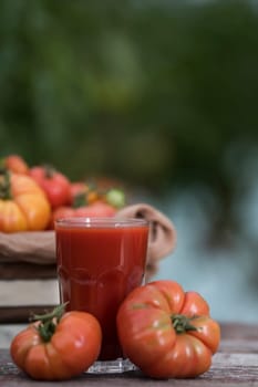 Fresh tomato juice, on a wooden background