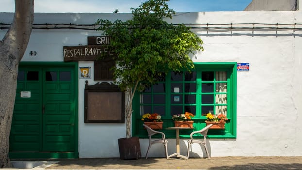 Yaiza, Lanzarote, Spain, March 2023: View on a cozy outside restaurant with street table in Yaiza, Lanzarote
