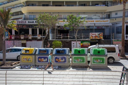 Costa Adeja, Tenerife, Spain August 08, 2022 - Waste bins for waste separation into different containers, in different colors on a street in the city of Costa Adeje on the island of Tenerife, Spain