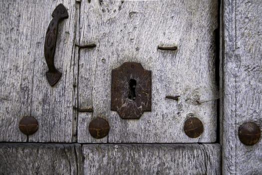 Detail of old wooden door abandoned and damaged by time