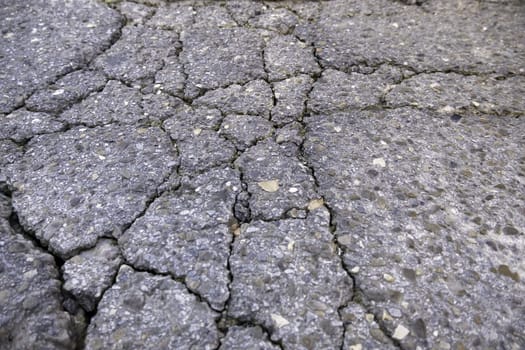 Detail of old road damaged by the passage of time, ruin and abandonment