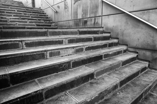 Detail of modern exterior staircase in the city, decorated with natural stone