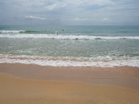 Summer sea with smooth waves blue sky sand and free space. Soft blue ocean wave or clear sea on clean sandy beach summer concept. Gorgeous Beach Landscape. Foam on sea water.