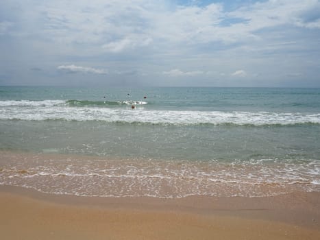 Summer sea with smooth waves blue sky sand and free space. Soft blue ocean wave or clear sea on clean sandy beach summer concept. Gorgeous Beach Landscape. Foam on sea water.