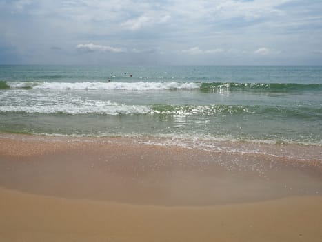 Summer sea with smooth waves blue sky sand and free space. Soft blue ocean wave or clear sea on clean sandy beach summer concept. Gorgeous Beach Landscape. Foam on sea water.
