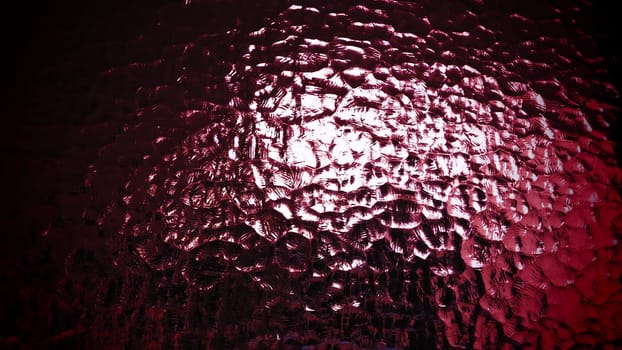 beautiful burgundy corrugated glass with a light and dark background. reflections of light.