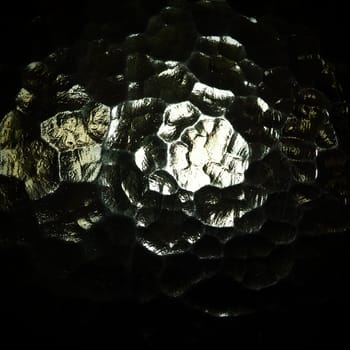 Corrugated glass, rear light source. Play of glare and reflections on a transparent uneven surface. Dark and light abstract asymmetric multi-illuminated planes. Abstract bumpy background.