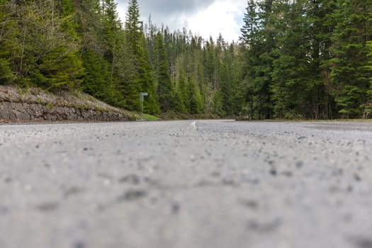 Winding road bends in a rural, desolate, mountain landscape in Slovakia, Europe.