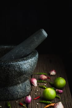 shrimp paste chilli sauce in a mortar stone with Ingredients to cook