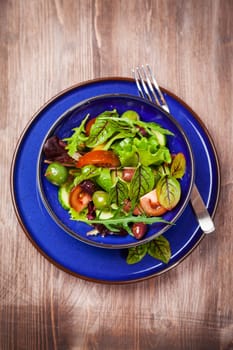 Mixed low calorie salad with olives and fresh avocado