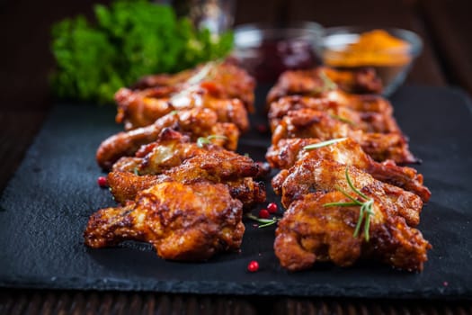 Spicy BBQ chicken wings with herbs and dips