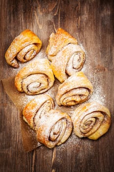 Homemade cinnamon rolls on wooden table