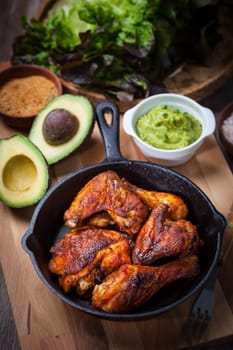 Grilled chicken legs and wings with guacamole, frish salad and spicies