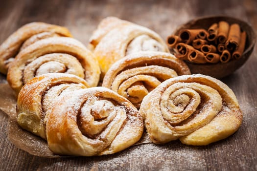 Homemade cinnamon rolls on wooden table