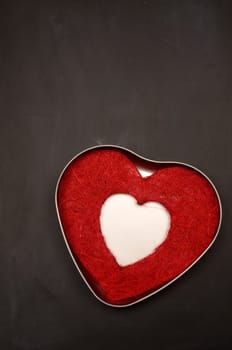 Heart shape on a blank blackboard with space for text or image