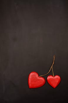 Two red heart shapes on a blackboard