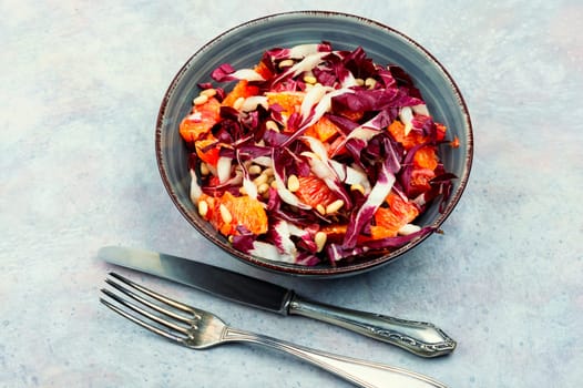 Freshly salad with chicory, orange and pine nuts. Radicchio salad