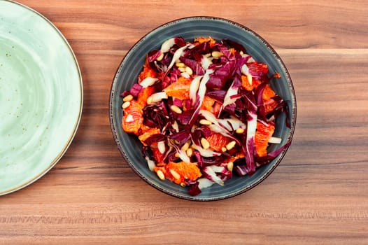 Freshly salad with chicory, orange and pine nuts. Radicchio salad