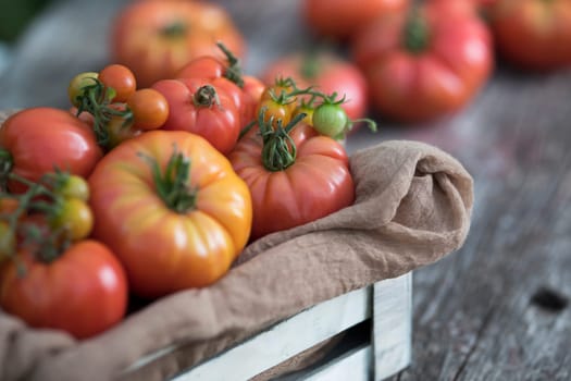 Vegetables, tomatoes on wooden desk