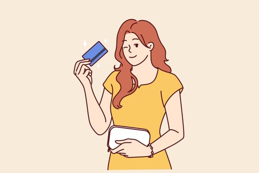 Woman with bank card winking recommend using reliable banking or credit product with large cashback. girl shows credit card intended for bargain purchases or cash withdrawals from ATM