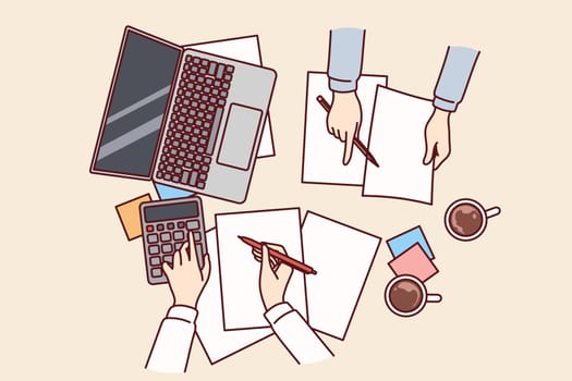 Hands of accountants doing financial accounting over table with payment documents and calculator, top view. Auditors calculate invoice or tax budget company and provide advisory services for business