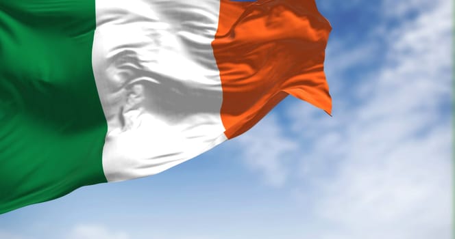 Ireland national flag waving in the wind on a clear day. Three vertical bands of green, white and orange. 3d illustration render. Rippled textile