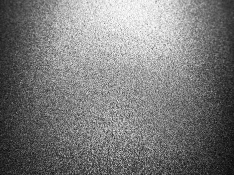 Black glitter texture christmas background. Bent shiny velvet paper.