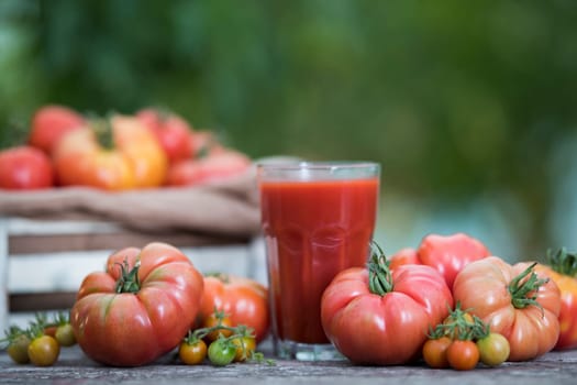 Fresh tomato juice, on a wooden background
