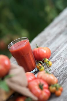 Fresh tomato juice, on a wooden background