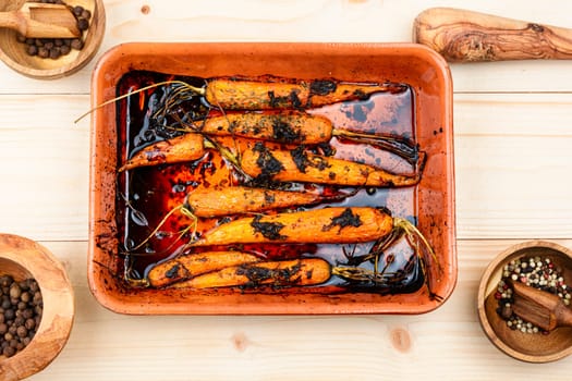 Baking dish with baked carrots. Flat lay, homemade food