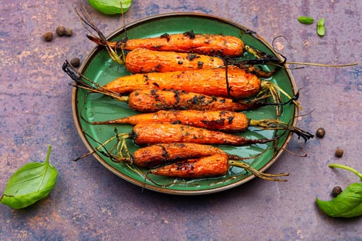 Baked with herbs and spices carrots. Tasty vegetable dish.