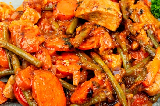 Stewed meat with carrots and green beans. Hot ragout with meat and vegetables.